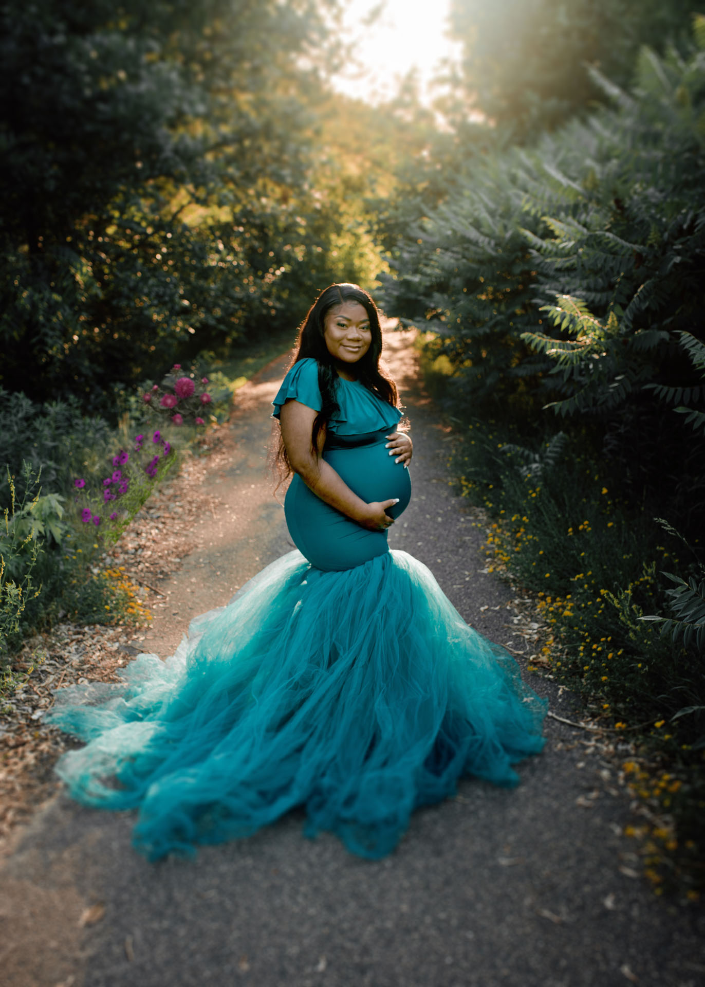mom in teal tulle gown on forest trail minneapolis maternity photographer