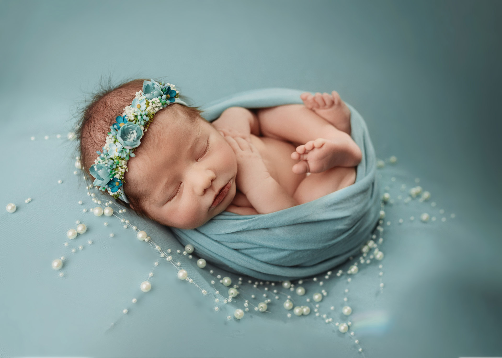 newborn girl on light teal with floral crown and pearls newborn photographer minneapolis minnesota