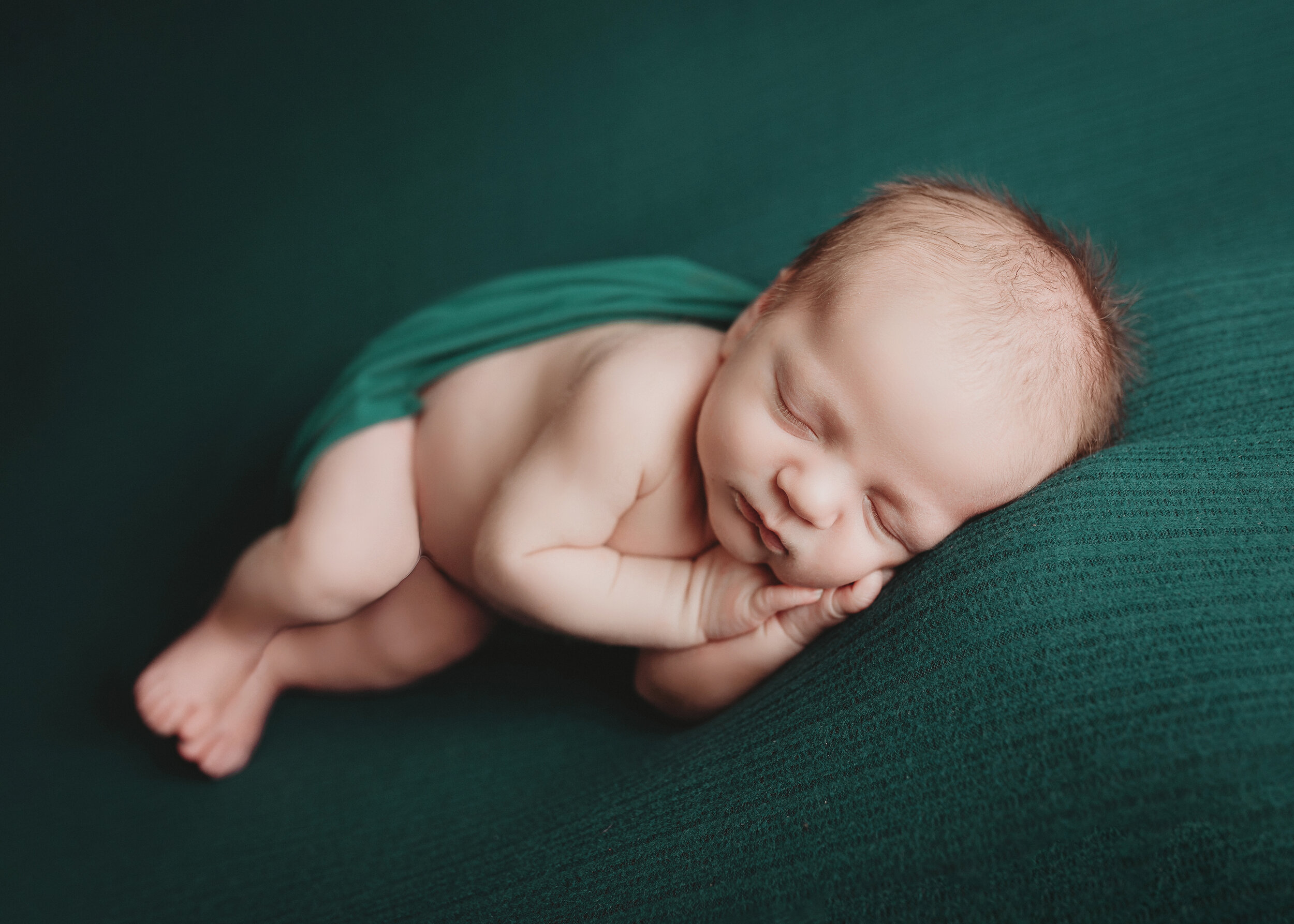 baby boy on emerald green for newborn photography session in minneapolis mn