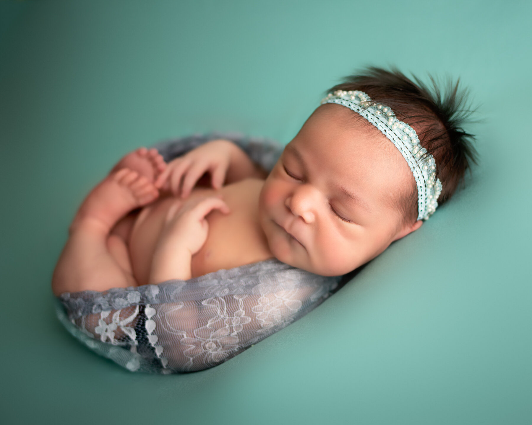 baby girl on teal and lace in egg pose for newborn photographer in minneapolis mn