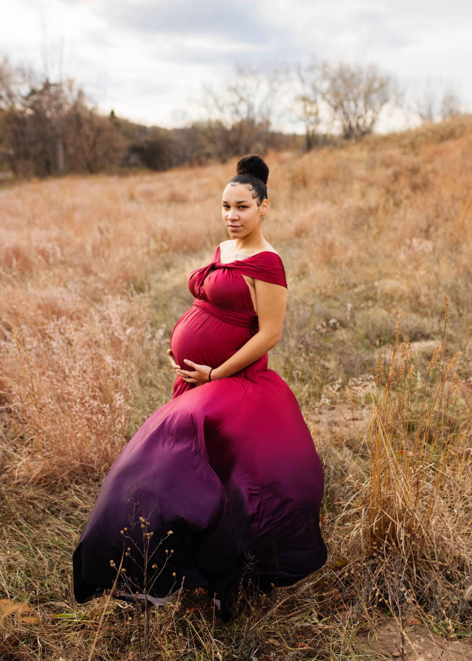 young pregnant mom in fuchsia to purple ombre eternity gown for maternity session in Minneapolis, MN