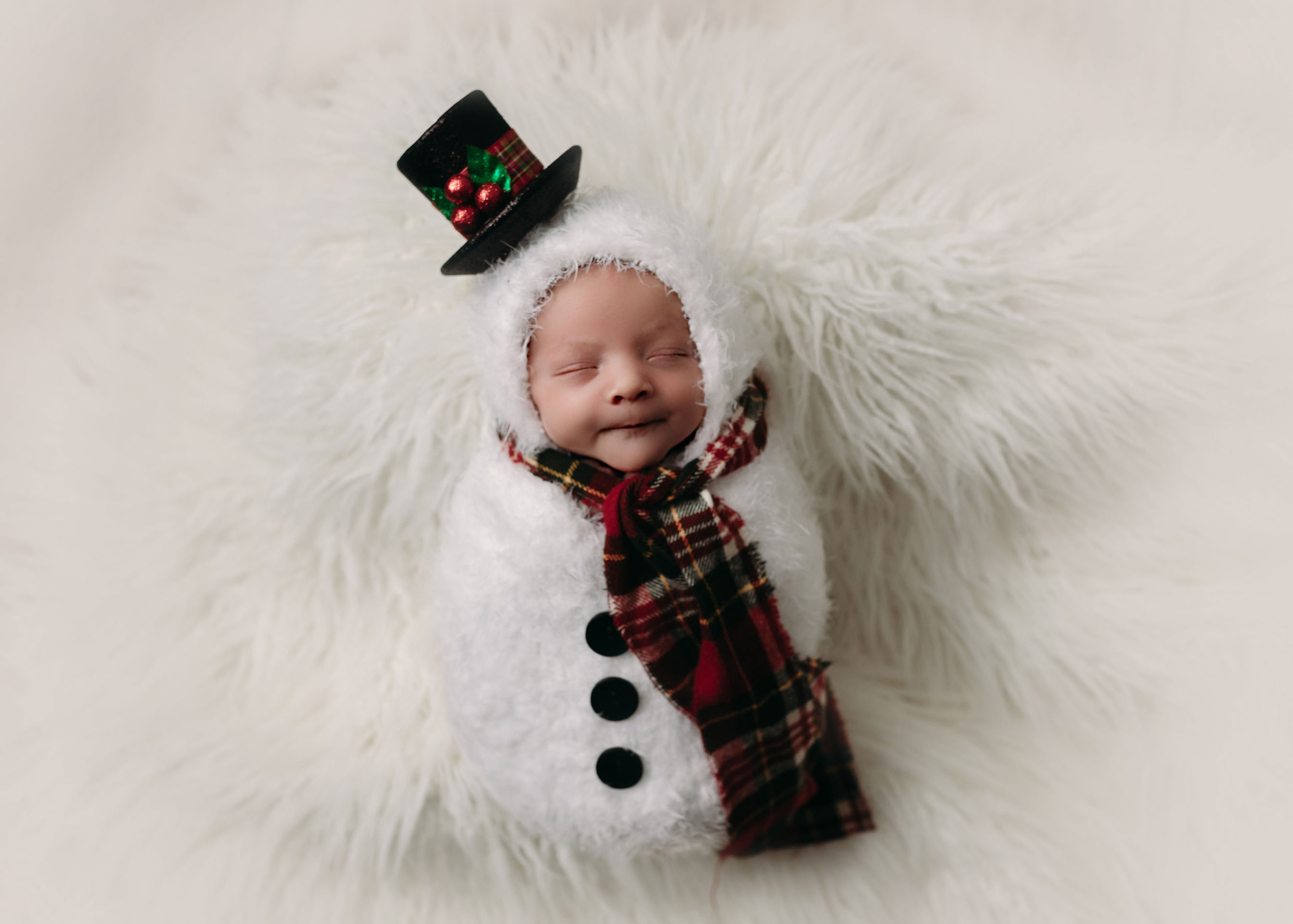 newborn boy in snowman swaddle on white flokati minneapolis minnesota newborn photographer