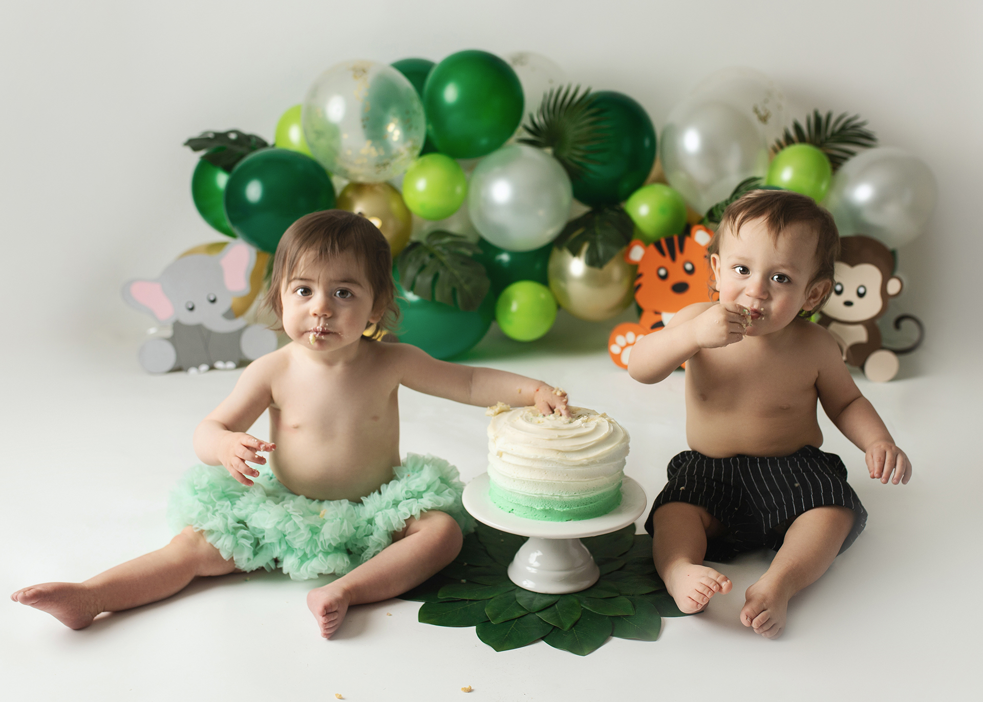twins eating cake for cake smash safari jungle theme in minneapolis